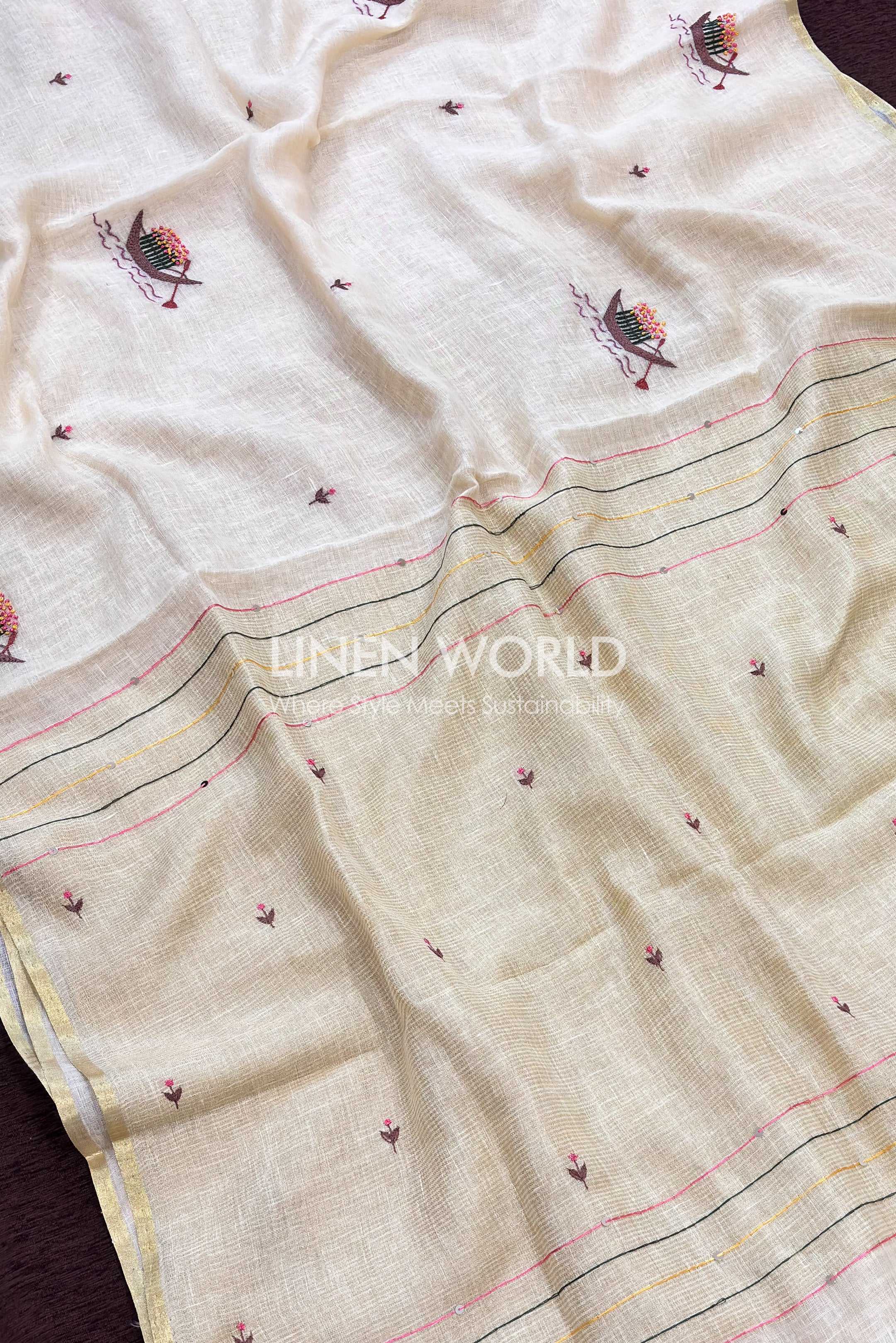 Off-white pure linen saree with gold zari border and flower boat embroidery for Onam celebrations exclusively from Linen World