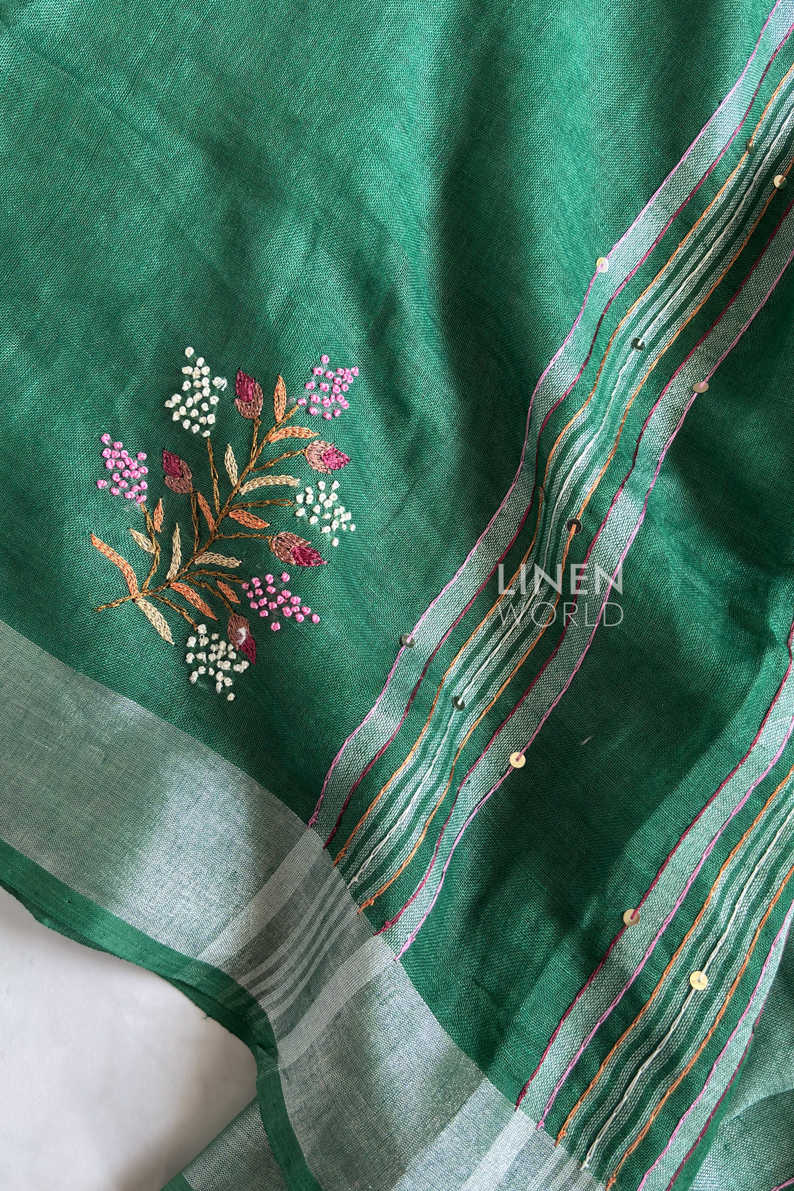 Green linen saree pallu showing intricate hand embroidery - Linen World