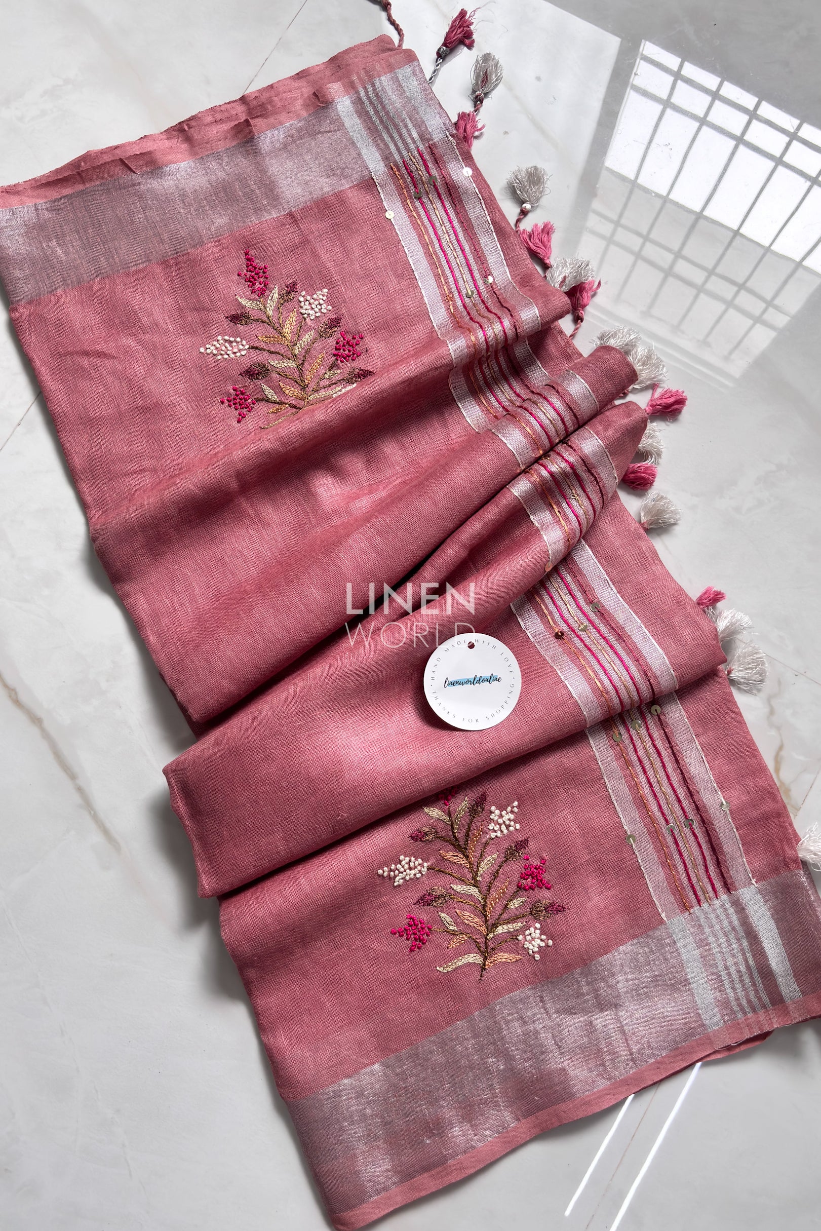 Mauve pink linen saree pallu showing intricate hand embroidery by Linen World
