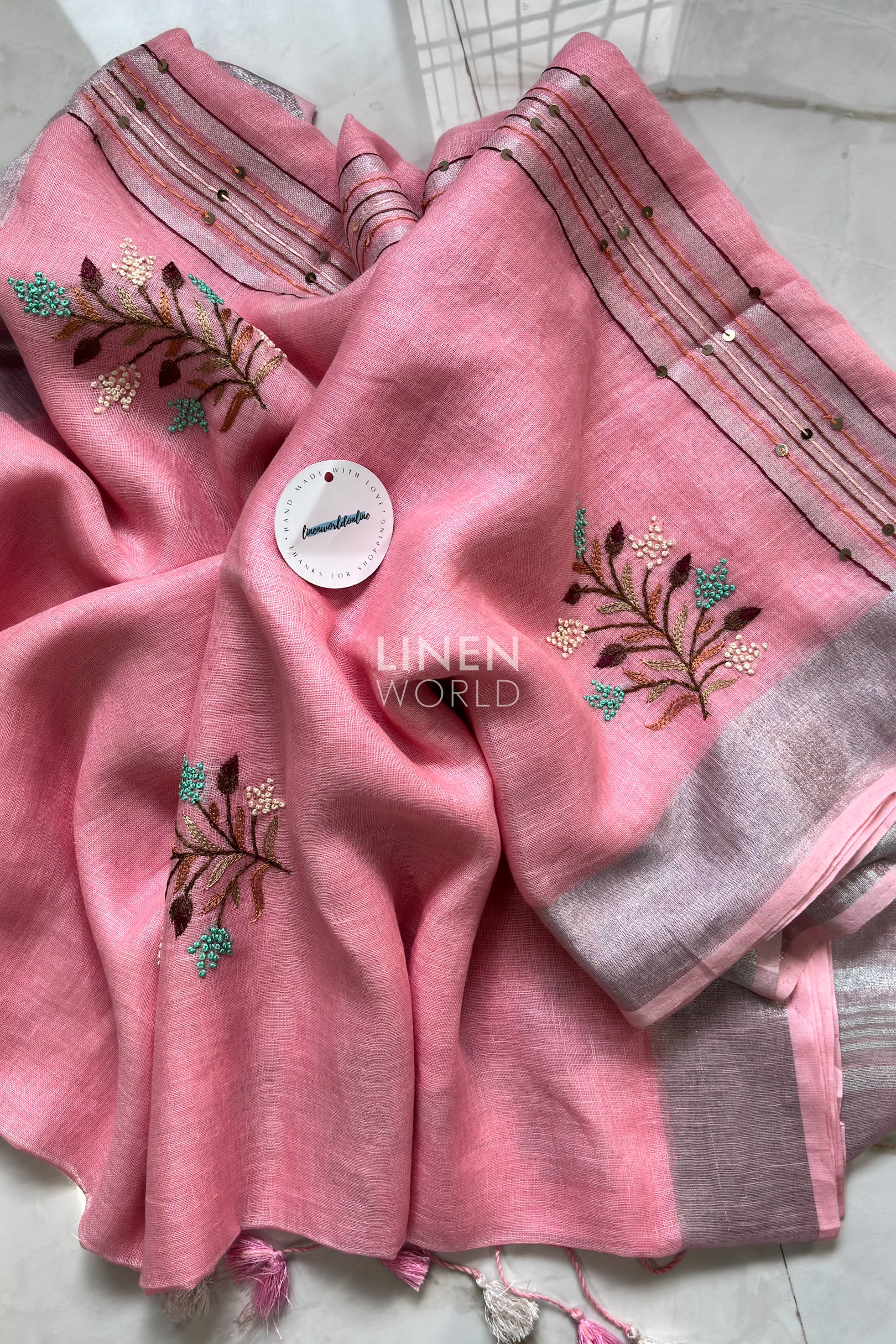 Close-up of French knot hand embroidery on pink pure linen saree by Linen World