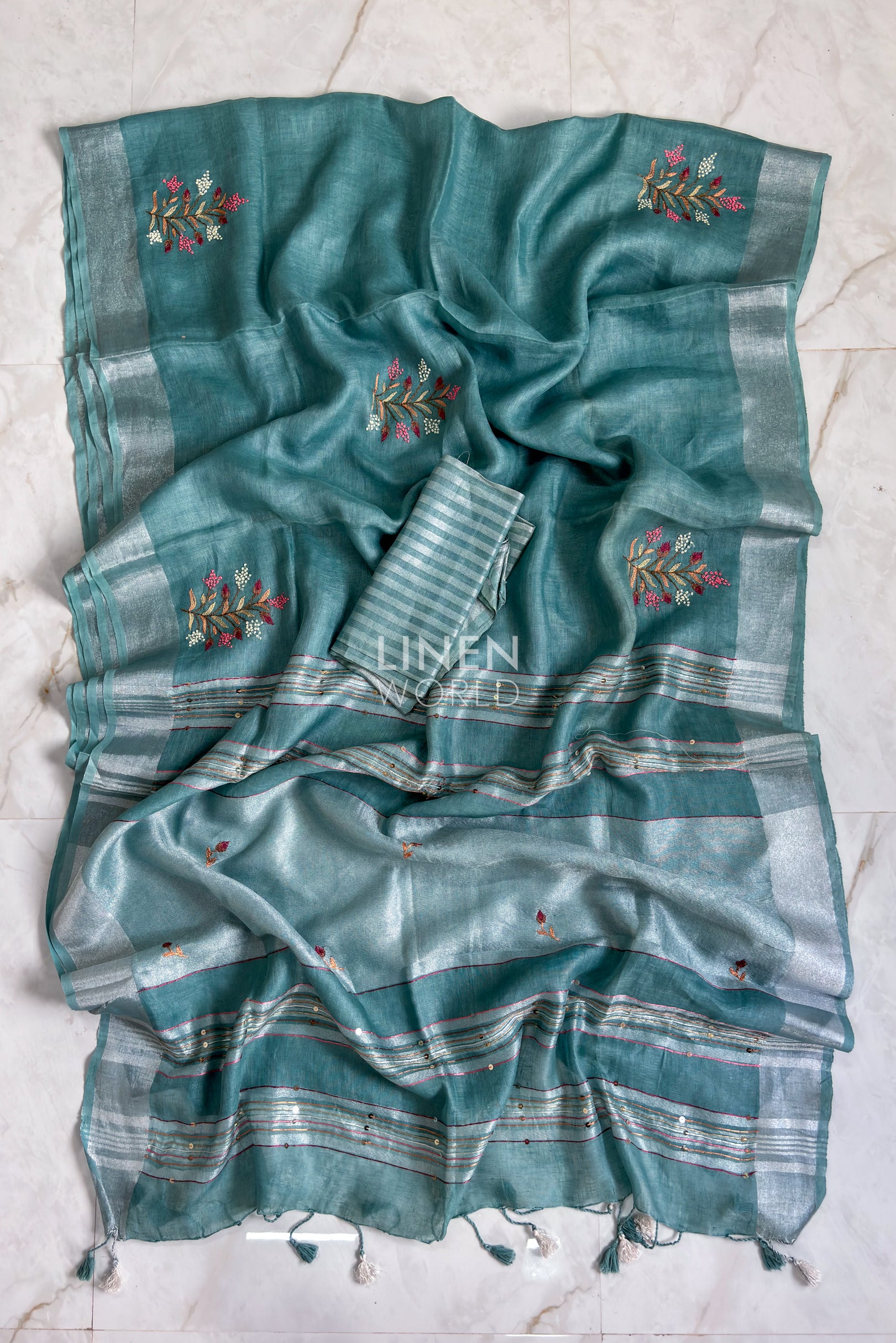 Teal blue linen saree pallu showing intricate hand embroidery by Linen World