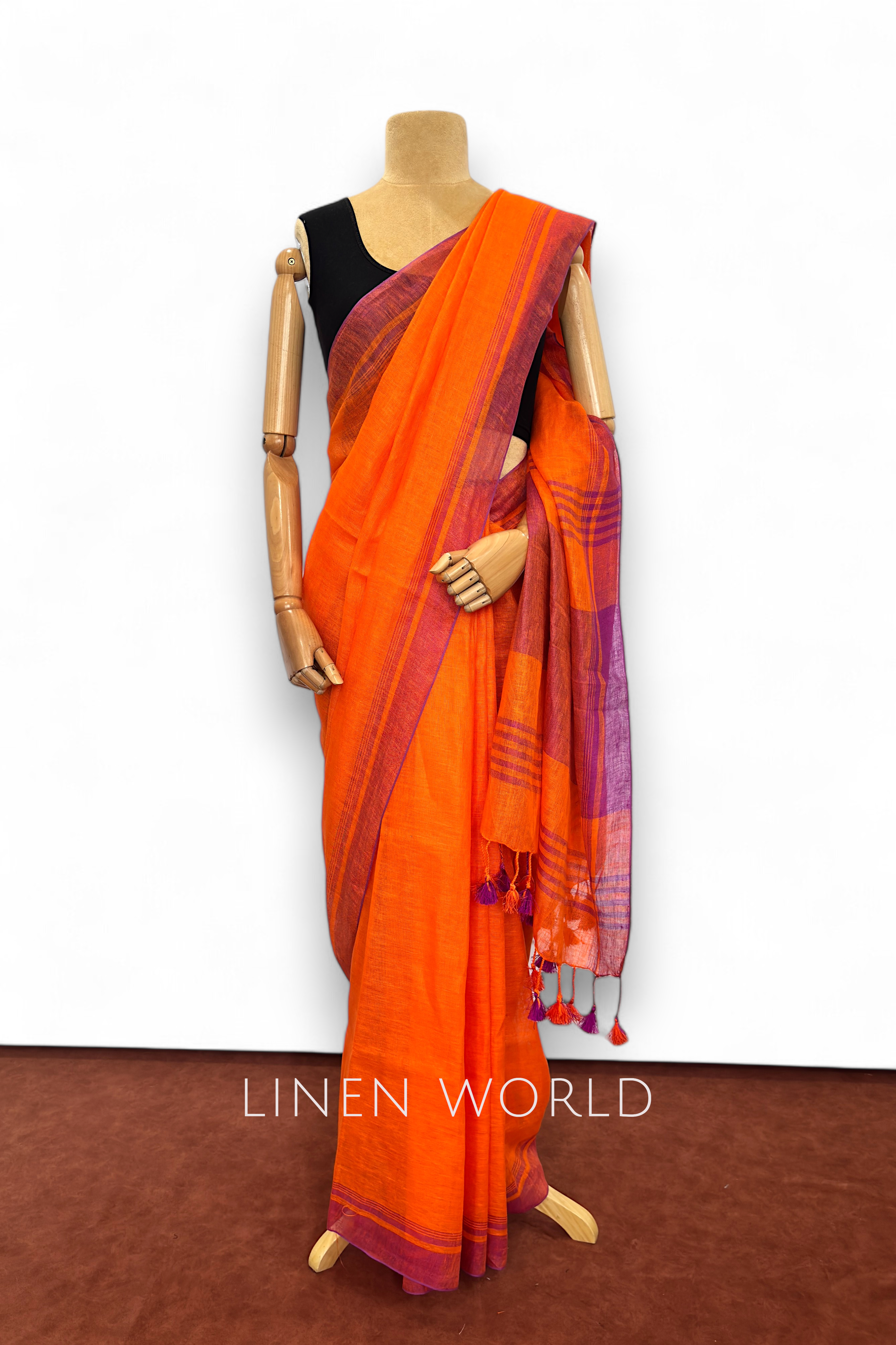 Vanya dark orange linen saree from Linen World, crafted in soft organic fabric.