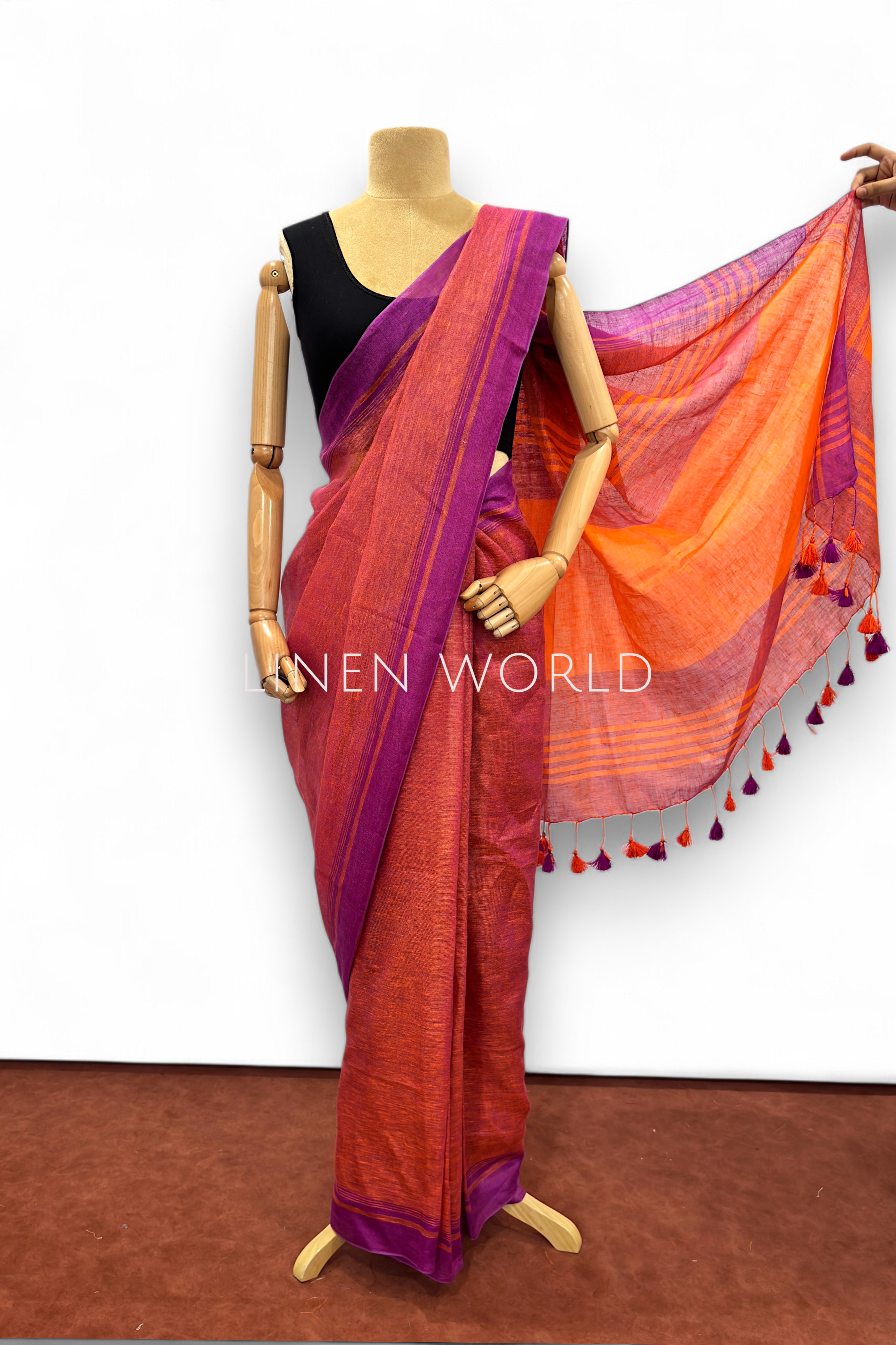 Office and daily wear purple linen saree with tassels branded 'Linen World'.