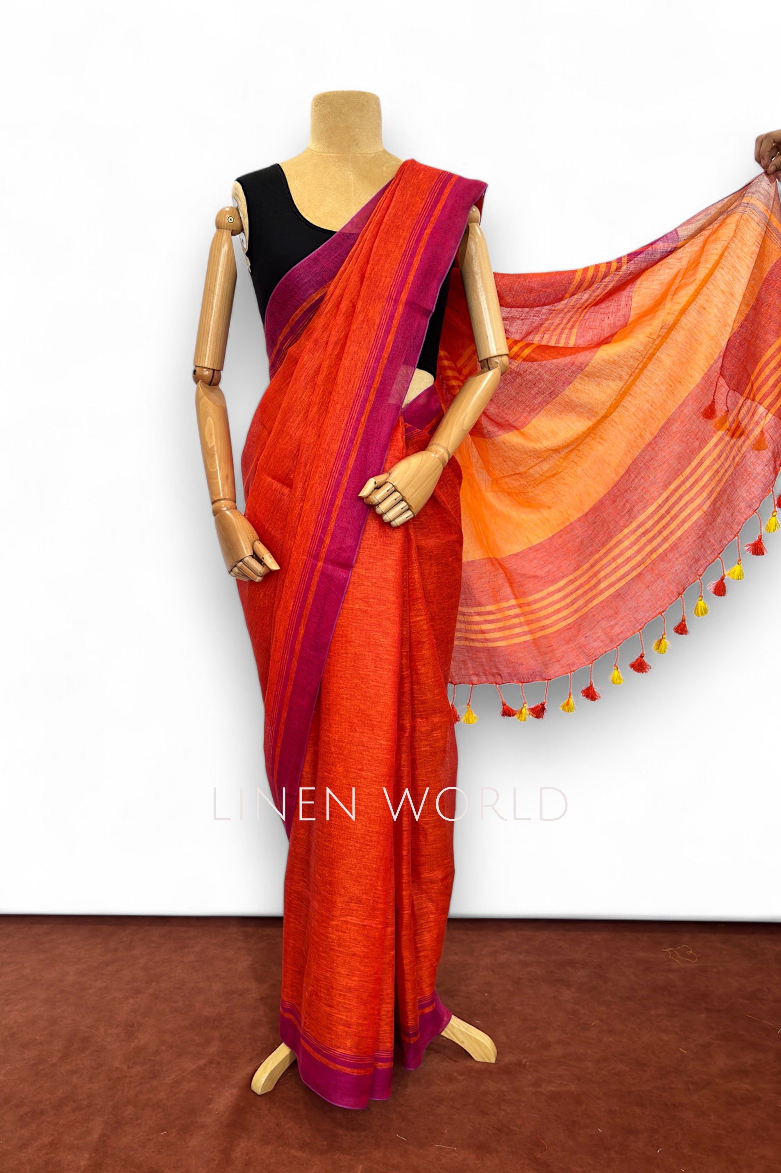 Office and daily wear red linen saree with tassels branded 'Linen World'.