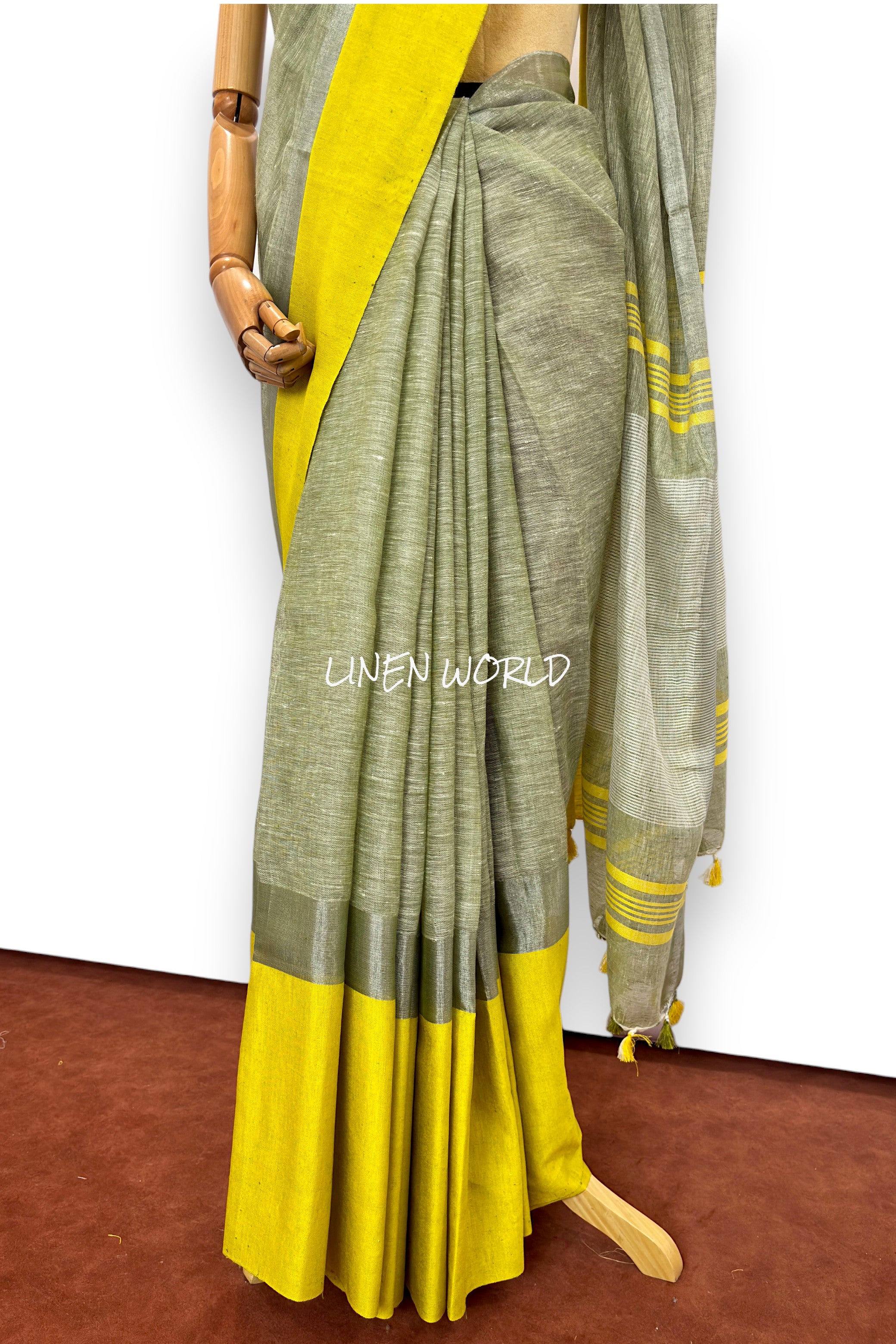 Darshini green linen saree showcasing fine weaving details