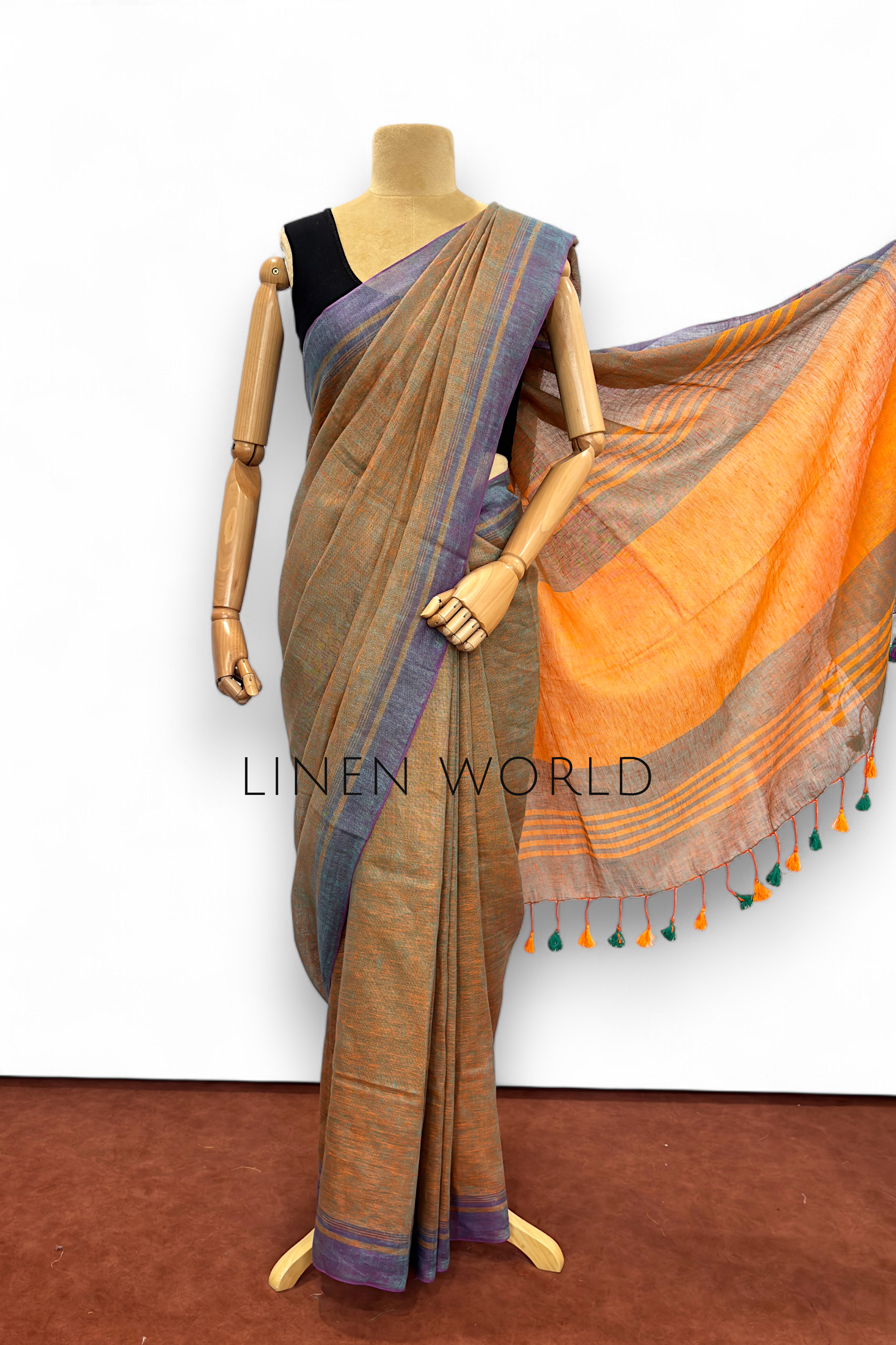 Office and daily wear green pure linen saree with tassels branded 'Linen World'.