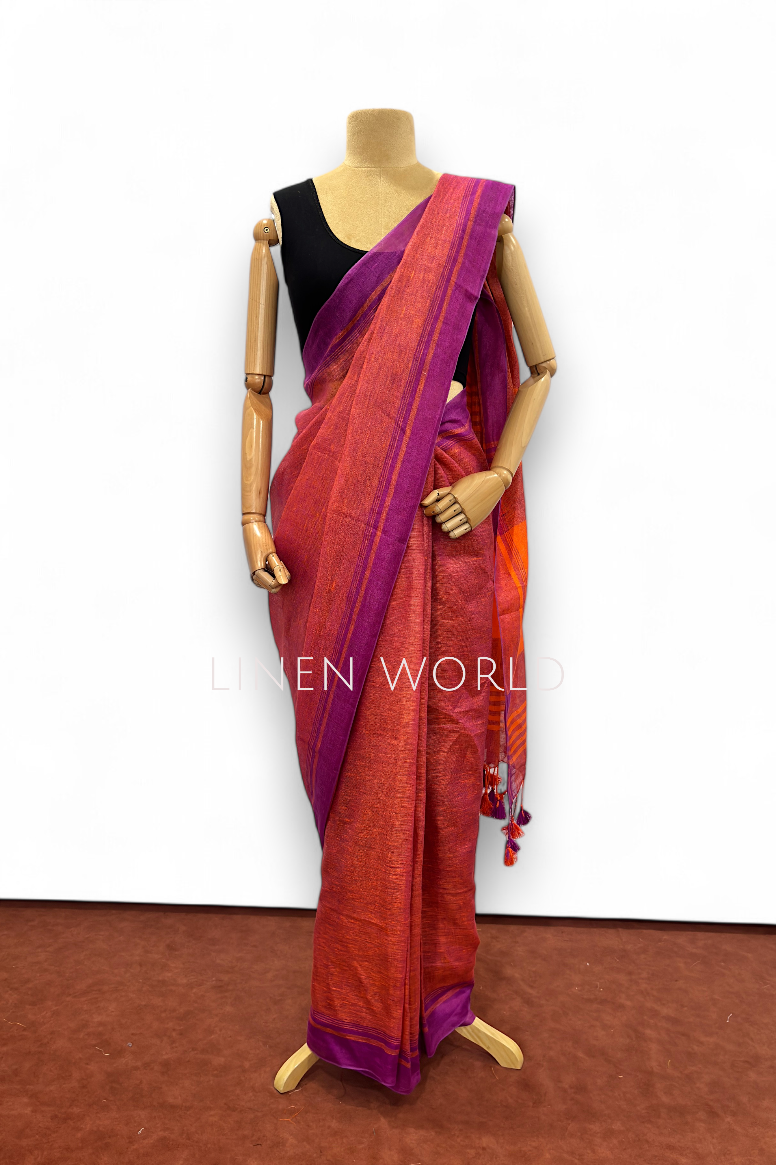 Office and daily wear purple pure linen saree with tassels branded 'Linen World'.