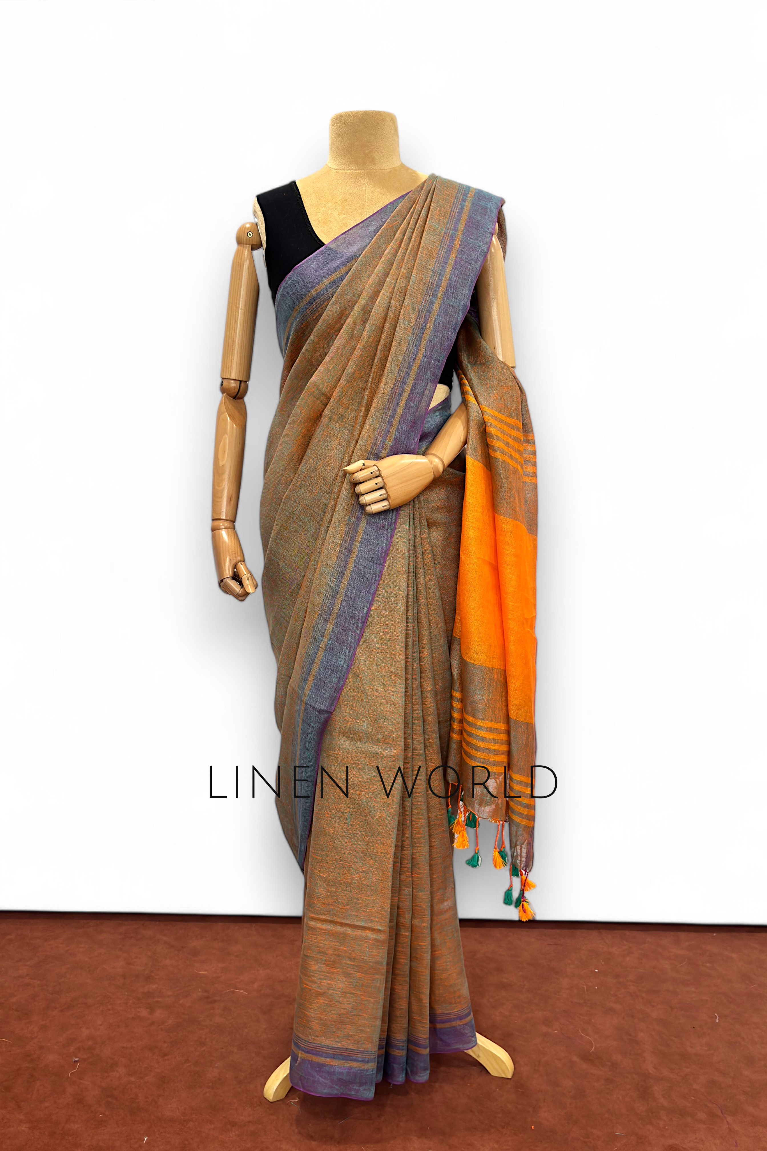 Office and daily wear green pure linen saree with tassels branded 'Linen World'.