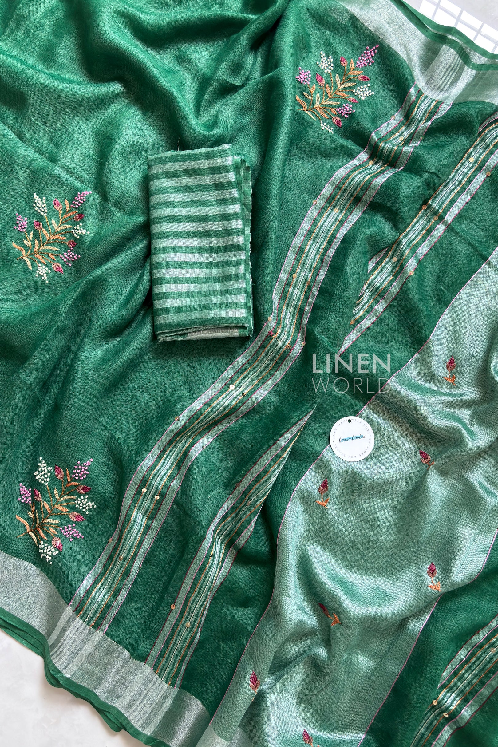 Close-up of French knot embroidery on green pure linen saree by Linen World