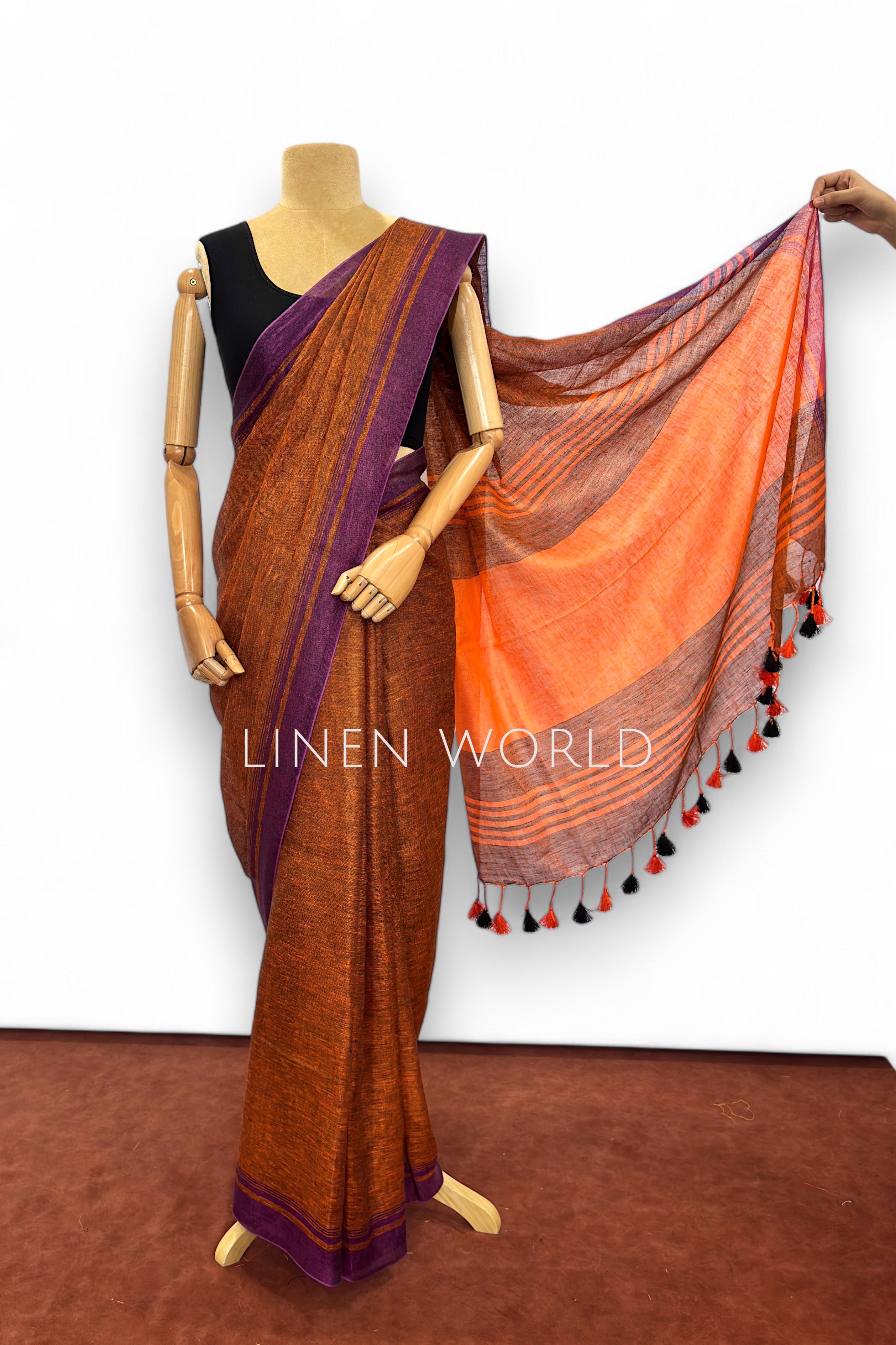 Vanya office and daily wear brown linen saree with tassels branded 'Linen World'.