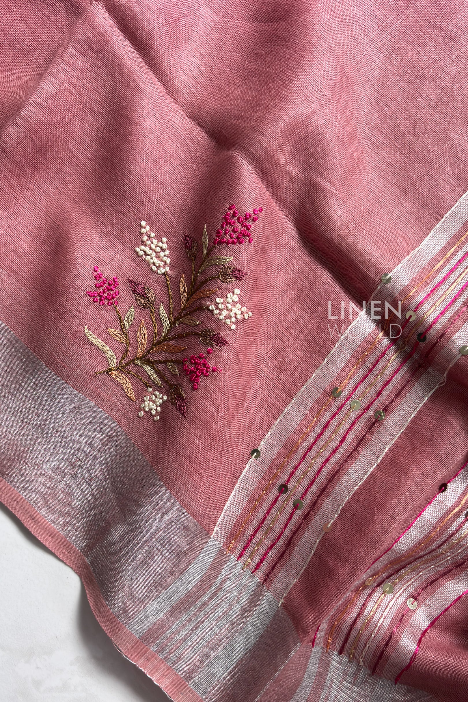 Close-up of French knot hand embroidery on mauve pink pure linen saree by Linen World
