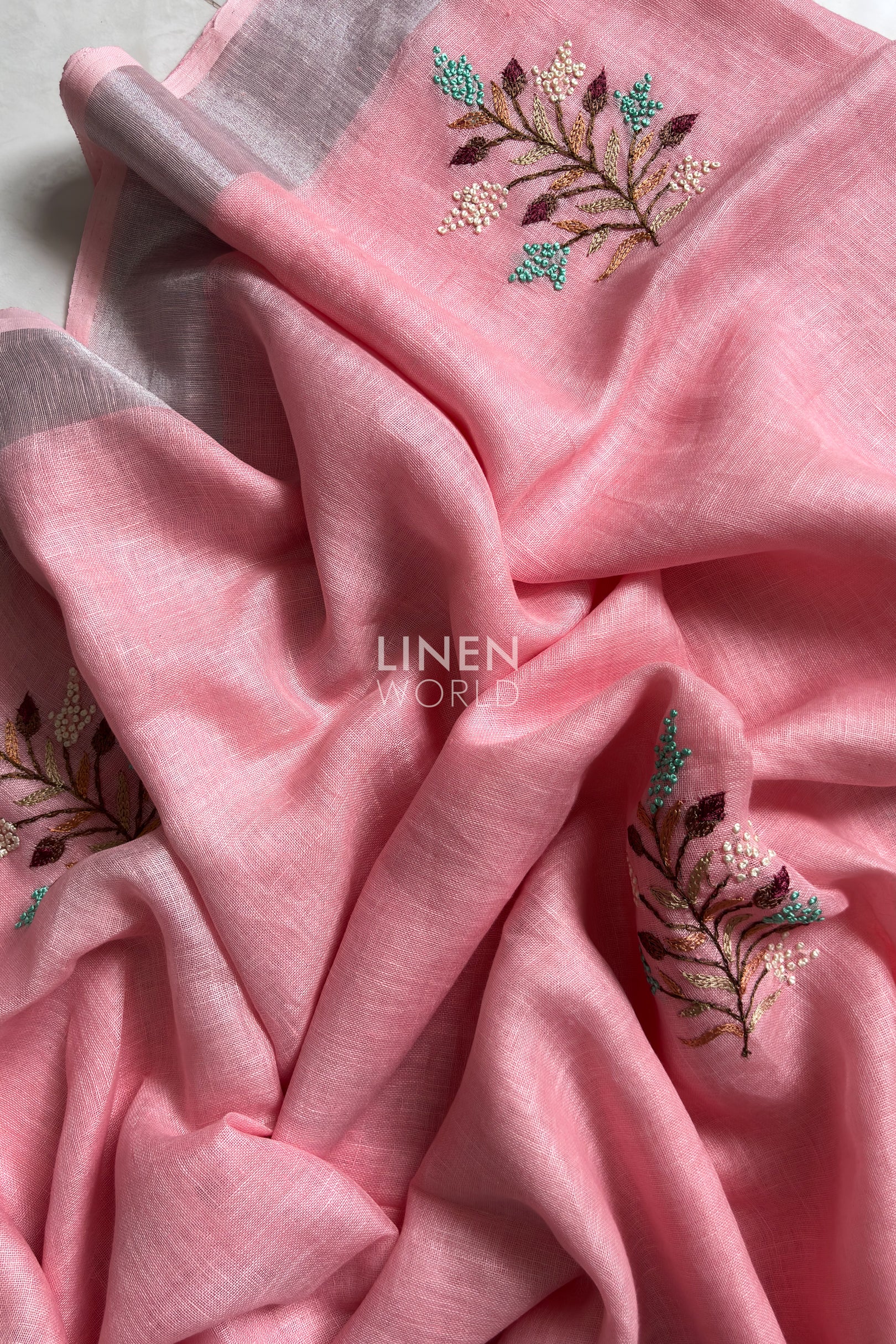 Close-up of French knot embroidery on pink pure linen saree by Linen World