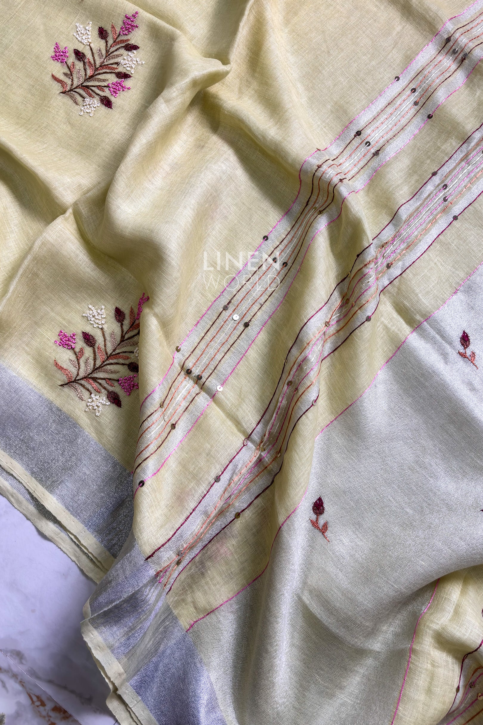 Close-up of French knot embroidery on yellow pure linen saree by Linen World